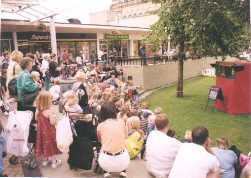 A puppet show by Living Daylights watched by the shoppers in Huddersfield