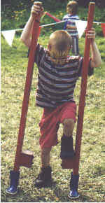 A young lad tries his hand at stiltwalking.