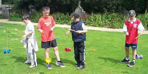 A group of lads learn the diabolo at a Kris Katchit Circus Workshop from Aurora's Carnival entertainment agency.