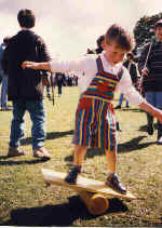 A budding young circus performer tries out a rola bola at a Kris Katchit Circus Workshop.