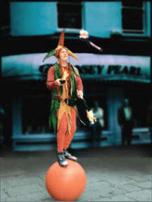 Jonathan displays his skills, juggling fire on a walking globe.