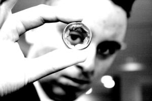 Szymon looks through a coin