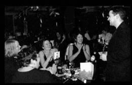 Marc Oberon performing table magic at a business dinner.