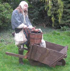 Gongfarmer fills his bucket with human excrement