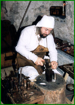 Hard at work hammering coins.