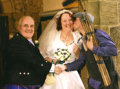 Lucky Sweep kisses the bride