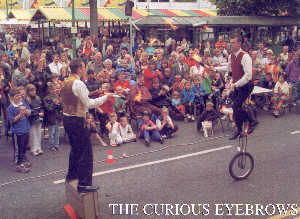 Winston & Stuart, The Curious Eyebrows entertain a huge crowd during one of their street shows.