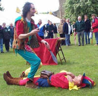 Ian juggles knives over Kris during a show at Ludlow Castle.