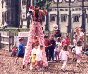 The Kids run through Kris Katchit's legs -He's a TALL stiltwalker