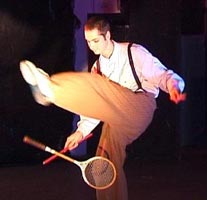 Tim manipulates a squask racket skillfully under his leg.