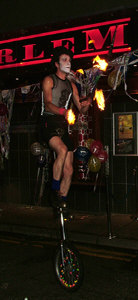 Urban Circus fire juggling on unicycle