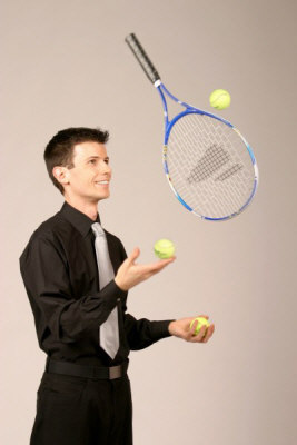 Sam Veale juggling tennis racquet and 3 balls