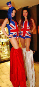 Union jack costumed stiltwalkers