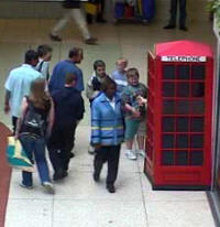 Interested shoppers wonder what the 'phone is doing in the shopping centre.