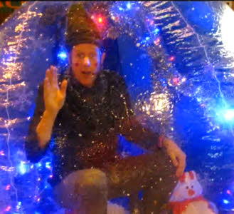 Elf in globe from circusperformers.co.uk and aurorascarnival.co.uk
